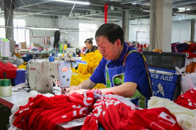 QINGDAO, CHINA - MAY 28: Workers are busy in front of an assembly line of flags for the FIFA World Cup at Qingdao Wonderful Flag Industry Co on May 28, 2026 in Qingdao, Shandong Province of China. As the 2026 FIFA World Cup is around the corner, production lines at a flag manufacturer in Qingdao, Shandong province, are running at full speed to produce various types of flags, many of which will soon appear in stadiums across North America.  Copyright: xVCGx 111644648655