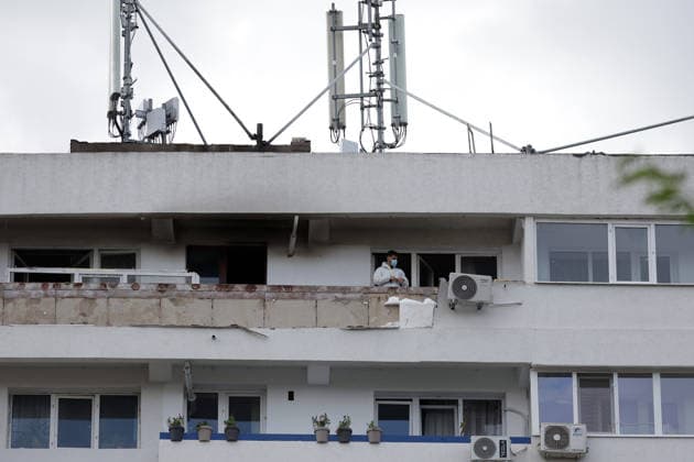 (260529) -- GALATI, May 29, 2026 -- A staff worker checks the residential apartment building damaged by a Russian drone in Galati, Romania, May 29, 2026. At least two people were injured after a drone struck a residential apartment building in Galati, Romania, near the border with Ukraine, local media reported Friday. (Photo by Xinhua) ROMANIA-GALATI-DRONE CristianxCristel 