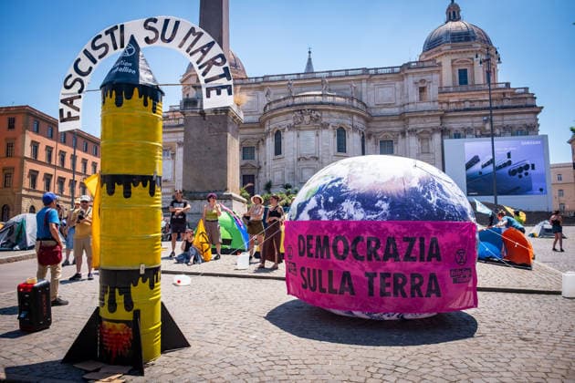 May 30, 2026, Rome, Rm, Italy: Extinction Rebellion activists are launching a 24-hour rally in Piazza dell Esquilino, just days before the 80th anniversary of the Italian Republic on June 2nd. They say: there is nothing to celebrate as long as rights, justice, and dignity continue to be denied. Oil extraction is imposed through violence and war to produce ever more energy, further increasing inequality. Activists assembled a rocket made of oil drums. It reads: Fascists on Mars. Democracy on earth reads the banner. Rome Italy  - ZUMAg256 20260530_znp_g256_002 Copyright: xMarcoxDixGianvitox