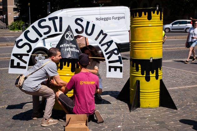 May 30, 2026, Rome, Rm, Italy: Extinction Rebellion activists are launching a 24-hour rally in Piazza dell Esquilino, just days before the 80th anniversary of the Italian Republic on June 2nd. They say: there is nothing to celebrate as long as rights, justice, and dignity continue to be denied. Oil extraction is imposed through violence and war to produce ever more energy, further increasing inequality. Activists assemble a rocket made of oil drums. It reads: Fascists on Mars. Rome Italy  - ZUMAg256 20260530_znp_g256_003 Copyright: xMarcoxDixGianvitox