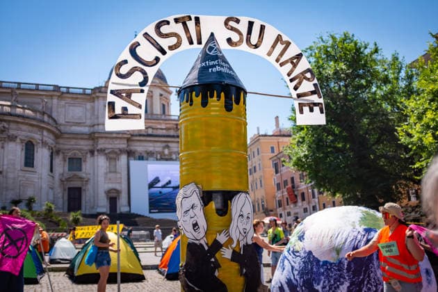 May 30, 2026, Rome, Rm, Italy: Extinction Rebellion activists are launching a 24-hour rally in Piazza dell Esquilino, just days before the 80th anniversary of the Italian Republic on June 2nd. They say: there is nothing to celebrate as long as rights, justice, and dignity continue to be denied. Oil extraction is imposed through violence and war to produce ever more energy, further increasing inequality. Activists pinned drawings of Donald Trump and Giorgia Meloni to a rocket made of oil drums. It reads: Fascists on Mars. Rome Italy  - ZUMAg256 20260530_znp_g256_005 Copyright: xMarcoxDixGianvitox