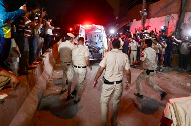 NEW DELHI, INDIA - MAY 30: Rescue personnel shift an injured person to an ambulance after a five-storey building collapsed on Westend Marg in Saidulajab, South Delhi, on May 30, 2026 in New Delhi, India. Several people are feared trapped under the rubble. The building housed a coaching institute on the ground floor. Construction work was ongoing on upper floors. Rescue operations are underway. Fire tenders and police are at the scene. Locals are assisting in the search efforts. (Photo by Raj K Raj Hindustan Times ) Multi-Storey Building Collapses In Delhi™s Saket; Several Feared Trapped