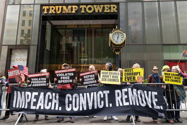 May 30, 2026, New York, New York, USA: Demonstrators join Rise and Resist s Impeach Convict Remove anti-Trump protest in front of Trump Tower on Fifth Avenue in Midtown Manhattan. People hold signs that read IMPEACHABLE OFFENSE VIOLATES FREEDOM OF ASSEMBLY VIOLATES FREE SPEECH DEFIES COURT ORDERS WAR CRIMES WON T HIDE SEX CRIMES MOST. CORRUPT. EVER. GRIFTER with an image of President Trump. Organizers call for impeachment stating that President Trump violates the Constitution, is covering up the Epstein Files, and is using his office to grift citing stock trades, crypto assets, the ballroom and the ,800,000,000 slush fund for Jan 6 insurrectionists. New York USA - ZUMAr174 20260530_znp_r174_015 Copyright: xGinaxMxRandazzox