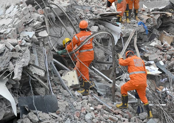 NEW DELHI, INDIA - MAY 31: NDRF team conducts rescue operations at the site of a five-storey building collapse on Westend Marg in Saidulajab, South Delhi, on May 31, 2026 in New Delhi, India. A rescue operation was conducted overnight to pull survivors out of the debris as authorities continue search efforts in the hope of pulling out more people. This is a multi-agency rescue operation, including teams from the National Disaster Response Force (NDRF), Delhi Fire Services (DFS), Delhi Police, Delhi Disaster Management Authority (DDMA), Municipal Corporation of Delhi (MCD), Civil Defence and CATS Ambulance Service. Heavy machinery, hydraulic cutters, victim-location cameras and sniffer dogs were used by the rescue operation teams to maximise