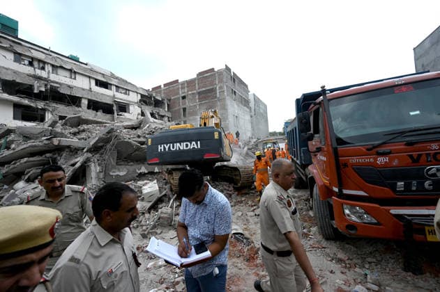NEW DELHI, INDIA - MAY 31: NDRF team conducts rescue operations at the site of a five-storey building collapse on Westend Marg in Saidulajab, South Delhi, on May 31, 2026 in New Delhi, India. A rescue operation was conducted overnight to pull survivors out of the debris as authorities continue search efforts in the hope of pulling out more people. This is a multi-agency rescue operation, including teams from the National Disaster Response Force (NDRF), Delhi Fire Services (DFS), Delhi Police, Delhi Disaster Management Authority (DDMA), Municipal Corporation of Delhi (MCD), Civil Defence and CATS Ambulance Service. Heavy machinery, hydraulic cutters, victim-location cameras and sniffer dogs were used by the rescue operation teams to maximise