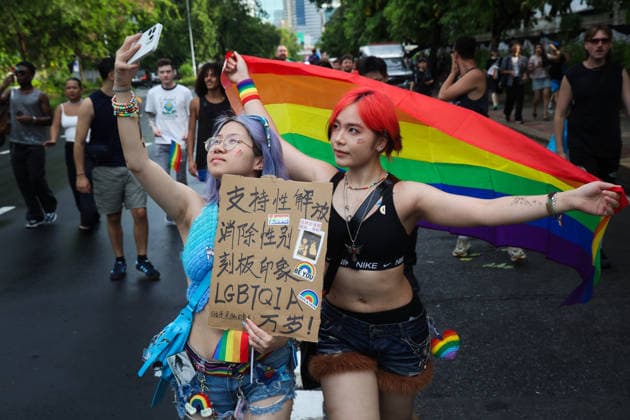 Bangkok Pride Parade in Thailand - 31 May 2026 Protesters take selfie with rainbow flags during the Bangkok Pride Parade 2026 on Silom Road in Bangkok. Bangkok Thailand Copyright: xSeksanxRochanametakulx xSOPAxImagesx IMG_6274