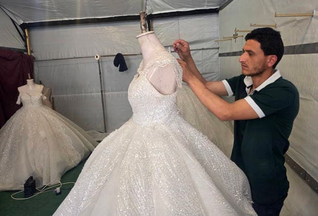 Customers browse wedding attire in Khan Younis despite wartime hardships Customers browse wedding dresses and suits inside a bridal shop in Khan Younis in the southern Gaza Strip on June 1, 2026, as Palestinians continue to uphold marriage traditions despite the ongoing war, widespread destruction, and difficult economic and humanitarian conditions. Shop owners say demand for wedding supplies remains present, though at a lower pace, as many families turn to less costly options amid declining incomes, rising prices, and shortages of goods linked to Israeli restrictions at border crossings. Photo by Tariq Mohammad APA Images Khan Yunis Gaza Strip Palestinian Territory 010626_Khan_Yunis_TM_00(14) Copyright: xapaimagesxTariqxMohammad xapaimagesx