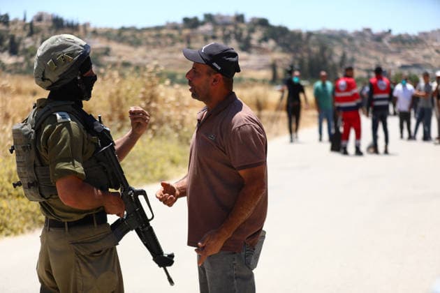 Israelis set fire to wheat fields in the West Bank HEBRON, WEST BANK, PALESTINE - JUNE 2: Israeli soldiers who arrived at the scene blocked the road and intervened against Palestinians trying to extinguish the fire as they set fire to large areas of wheat fields in the town of Izna, in Hebron, West Bank, Palestine, on June 2, 2026. Wisam Hashlamoun Anadolu Hebron West Bank. Editorial use only. Please get in touch for any other usage.  Copyright: x2026xAnadoluxWisamxHashlamounx