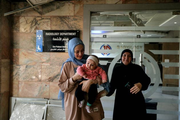 June 2, 2026, Tyre, Tyre, Lebanon: Battoul carries her 4 month old daughter Fatima at the entrance of Radiology department at Jabal Amel Hospital that was partially destroyed in Israeli air strikes in the southern Lebanese port city of Tyre. Battoul, who is married to an employee in the hospital, fled her apartment to live with her husband and daughter inside the sanatorium. Clashes have continued in southern Lebanon despite Israel and Hezbollah accepting a US plan for a partial ceasefire. President Donald Trump said he had spoken to both sides and they agreed that all shooting will stop , after Iran warned Israeli military actions in Lebanon were a threat to the US-Iran ceasefire. Tyre Lebanon - ZUMAn313 20260602_zip_n313_013 Copyright: xMarwanxNaamanix