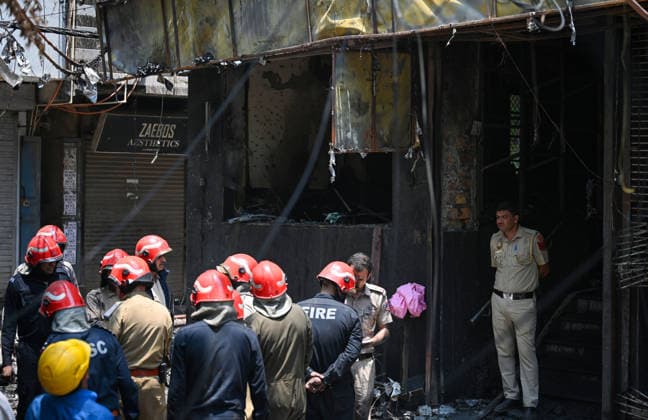 NEW DELHI, INDIA - JUNE 3: Firefighters and rescue personnel conduct rescue and recovery operations after a massive fire broke out in a five-storey building housing a restaurant and bed-and-breakfast guest accommodation in the highly congested Hauz Rani area of Malviya Nagar on June 3, 2026 in New Delhi, India. The blaze at the Flourish Stay B&B and Lemon Green Restaurant started around 8.30 am and quickly spread, catching everybody unawares. Rescue workers, including many locals, rushed to the spot to pull out those trapped inside the five-floor narrow building. About 40 people were rescued and rushed to hospital where 21 were declared brought dead, officials said. The death toll could rise with several of the injured in a critical conditi