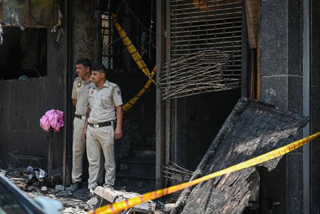 NEW DELHI, INDIA - JUNE 3: Firefighters and rescue personnel conduct rescue and recovery operations after a massive fire broke out in a five-storey building housing a restaurant and bed-and-breakfast guest accommodation in the highly congested Hauz Rani area of Malviya Nagar on June 3, 2026 in New Delhi, India. The blaze at the Flourish Stay B&B and Lemon Green Restaurant started around 8.30 am and quickly spread, catching everybody unawares. Rescue workers, including many locals, rushed to the spot to pull out those trapped inside the five-floor narrow building. About 40 people were rescued and rushed to hospital where 21 were declared brought dead, officials said. The death toll could rise with several of the injured in a critical conditi