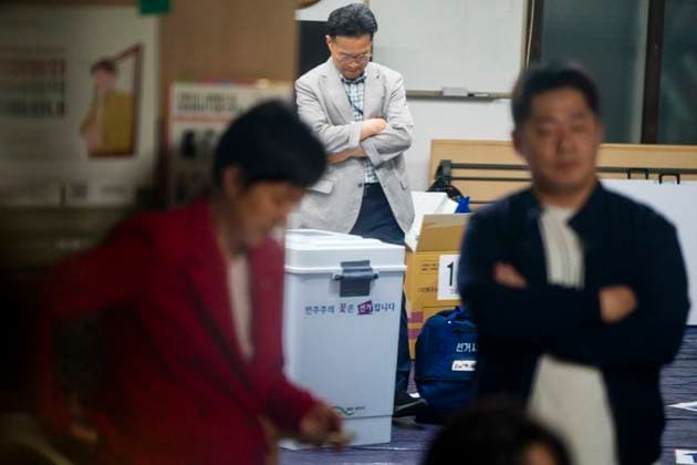 June 4, 2026, Seoul, South Korea: Poll workers guard ballot boxes as far-right protesters surround a voting center and block its workers from sending ballots for counting in South KoreaÃ¢â‚¬â ¢s local elections, on Thursday, June 4, 2026 in Seoul, South Korea. Some people were unable to vote because several voting centers ran out of ballots; the National Election Commission admitted to not printing enough paper ballots for the election, which will determine several crucial local races, including the mayors of Seoul and Busan. Seoul South Korea - ZUMAh163 20260604_znp_h163_012 Copyright: xJintakxHanx