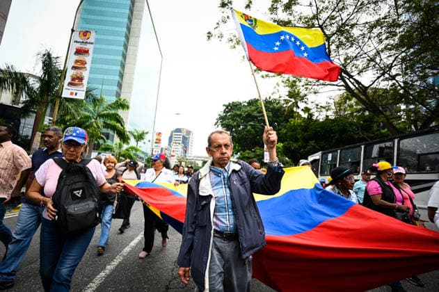 Protesters in Venezuela demand higher wages and presidential elections CARACAS, VENEZUELA - JUNE 3: A protester holds a Venezuelan flag during a march by public sector workers, students, and relatives of political prisoners heading to the U.S. Embassy to demand higher wages, decent working conditions, the release of political prisoners, and the calling of presidential elections in Caracas, Venezuela, June 3, 2026. Maxwell Briceno Anadolu Caracas Venezuela. Editorial use only. Please get in touch for any other usage.  Copyright: x2026xAnadoluxMaxwellxBricenox