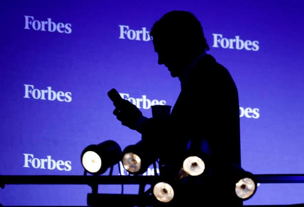 An attendee looks at his cell phone at the 2025 Forbes Iconoclast Summit on Wednesday, June 3, 2026 at Gotham Hall in New York City.  NYP20260603143 JohnxAngelillo