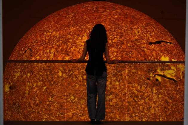 Preview of The Sun and The Moon: Art Inspired by the Celestial exhibition in London LONDON, UNITED KINGDOM - JUNE 4: A woman observes Helios, a large-scale sun installation by British artist Luke Jerram, during the press preview of The Sun and The Moon: Art Inspired by the Celestial exhibition at the Saatchi Gallery in London, United Kingdom on June 4, 2026. Rasid Necati Aslim Anadolu London United Kingdom. Editorial use only. Please get in touch for any other usage.  Copyright: x2026xAnadoluxRasidxNecatixAslimx