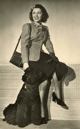 RECORD DATE NOT STATED Austrian actress Jenny Jugo posing with a large dark poodle dog, 1930s  !ACHTUNG AUFNAHMEDATUM GESCHÄTZT!