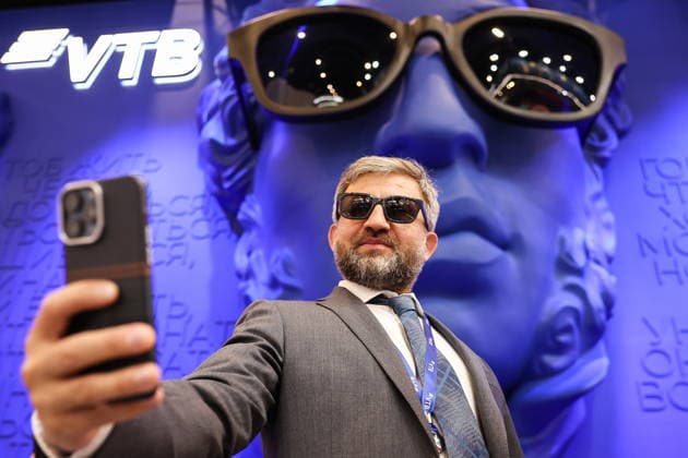 RUSSIA, ST PETERSBURG - JUNE 4, 2026: A man takes a selfie by a stand of VTB at the 2026 St Petersburg International Economic Forum at the ExpoForum Convention and Exhibition Centre. Donat Sorokin TASS  93360192