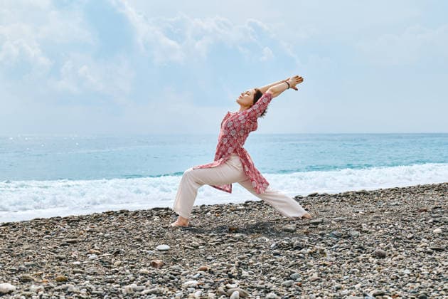 Practicing yoga on a Mediterranean beach model released, Symbolfoto, CATF00966