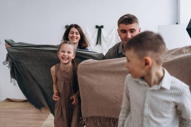 Happy family enjoying quality time playing with blankets indoors model released, Symbolfoto property released, KANF00193