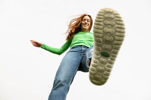 Low angle view of a stepping shoe with red hair and green shirt model released, Symbolfoto, LMCF02797