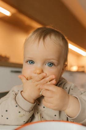 Portrait indoors learning self feeding with baby led weaning model released, Symbolfoto property released, VIVF01839