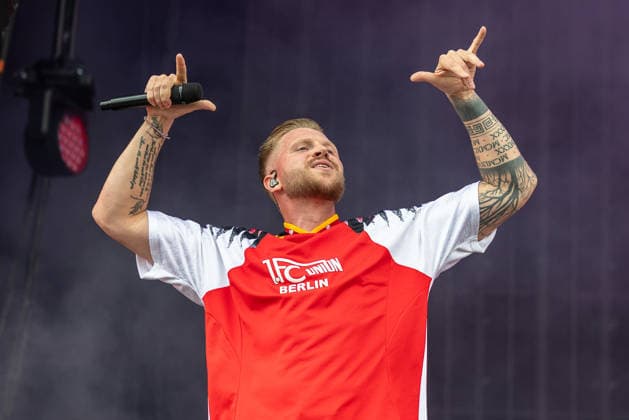 Musikfestival Rock im Park 2026 - FINCH, Nürnberg, 06.06.2026 Rapper Finch bei seinem Auftritt auf der Buehne. Er traegt ein Trikot des 1. FC Union Berlin und haelt das Mikrofon mit ausgestreckten Armen in die Hoehe. Nürnberg Bayern Deutschland *** Music festival Rock im Park 2026 FINCH, Nuremberg, 06 06 2026 Rapper Finch performing on stage Wearing a 1 FC Union Berlin jersey and holding the microphone aloft with outstretched arms Nuremberg Bavaria Germany 20260606-1V9A0223-M4000