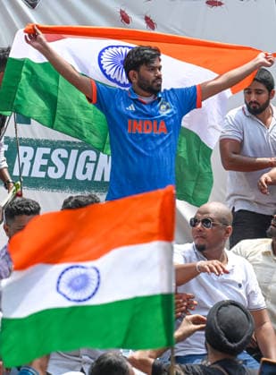 NEW DELHI, INDIA - JUNE 6: Cockroach Janta Party (CJP) founder Abhijeet Dipke, in blue, during a protest demanding the resignation of Union Education Minister Dharmendra Pradhan over alleged examination-related lapses, at the Jantar Mantar on June 6, 2026 in New Delhi, India. Members and supporters of the Cockroach Janta Party (CJP) protest at Jantar Mantar to demand the resignation of Union Minister of Education, Dharmendra Pradhan. They claimed him to be directly responsible for the recent exam paper leaks in major national-level examinations across the country, including NEET. The party was started as a satirical online movement after remarks made by Chief Justice Surya Kant during a hearing. CJI Kant compared a section of young un