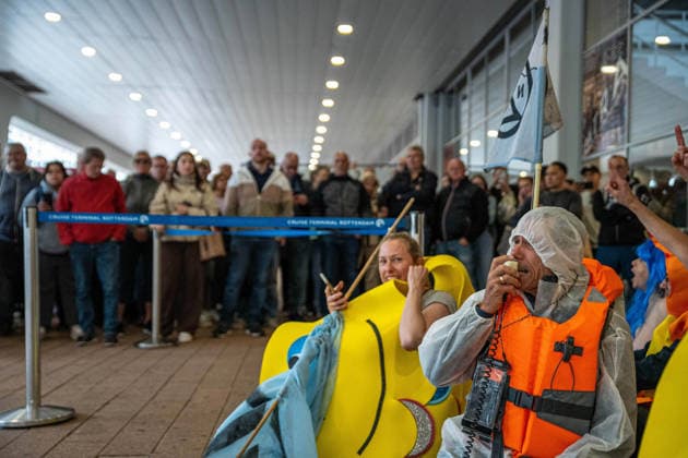 June 6, 2026, Rotterdam, South Holland, Netherlands: Rotterdam, Netherlands, 6 June 2026. An activist chants protest slogans before a large crowd of unhappy travelers. Extinction Rebellion activists blocked the entrance to the Cruise Terminal on the Wilhelminakade on World Anti-Cruise Day. This temporarily preventing cruise passengers from boarding a moored cruise ship. Several activists were detained, and four were arrested. Rotterdam Netherlands  - ZUMAp202 20260606_zip_p202_009 Copyright: xJamesxPetermeierx