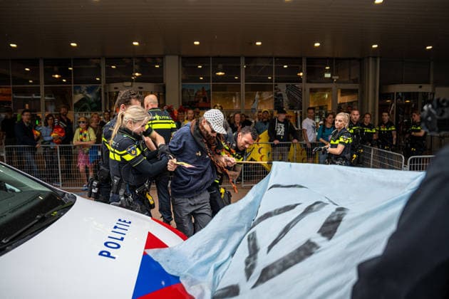 June 6, 2026, Rotterdam, South Holland, Netherlands: Rotterdam, Netherlands, 6 June 2026. Extinction Rebellion activists blocked the entrance to the Cruise Terminal on the Wilhelminakade on World Anti-Cruise Day. This temporarily preventing cruise passengers from boarding a moored cruise ship. Several activists were detained and four were arrested. Rotterdam Netherlands  - ZUMAp202 20260606_zip_p202_004 Copyright: xJamesxPetermeierx