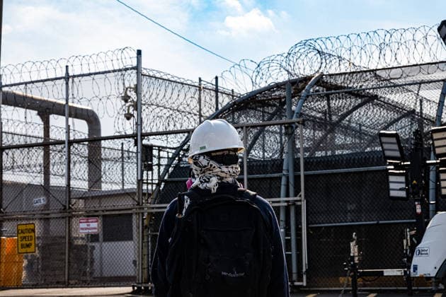 June 6, 2026, Newark, New Jersey, USA: A protester in protective gear stands outside the gates of the Delaney Hall immigration detention center in Newark. Newark USA - ZUMAh196 20260606_znp_h196_002 Copyright: xTomxHudsonx