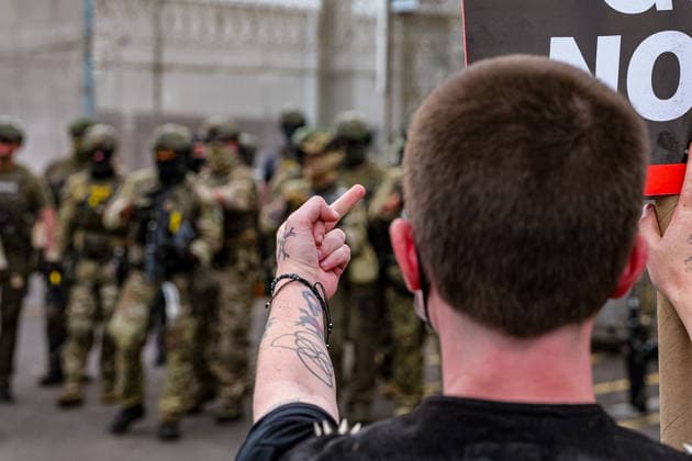 June 6, 2026, Newark, New Jersey, USA: A protester gestures at ICE agents outside the Delaney Hall immigration detention center in Newark. Newark USA - ZUMAh196 20260606_znp_h196_005 Copyright: xTomxHudsonx