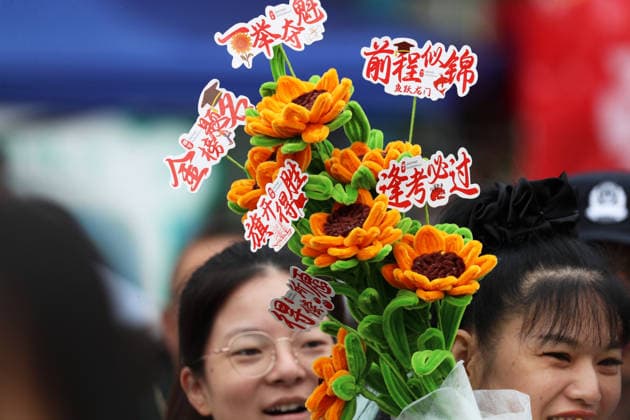 XUCHANG, CHINA - JUNE 07: Students parents hold sunflowers to cheer up for their children outside the examination venue for the 2026 China s National College Entrance Exam on June 7, 2026 in Xuchang, Henan Province of China. A total of 12.9 million students across China are set to attend the gaokao, or the national college entrance exam, starting from June 7.  Copyright: xVCGx 111646626765