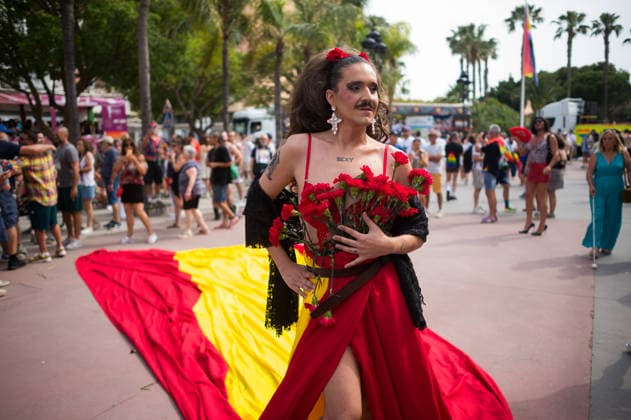 June 6, 2026, Malaga, Spain: A person wearing a dress with the spanish flag is seen holding roses as he .takes part in a demonstration in support of the rights of LGTBIQ+ people, as part of the LGTBIQ+ Pride celebrations. The LGTBIQ+ Pride of Torremolinos is internationally known as a meeting point for LGTBIQ+ people in a colourful and festive atmosphere, where thousands of people celebrate the fight of the LGTBIQ+ movement for equality and respect. Malaga Spain - ZUMAs197 20260606_aaa_s197_384 Copyright: xJesusxMeridax
