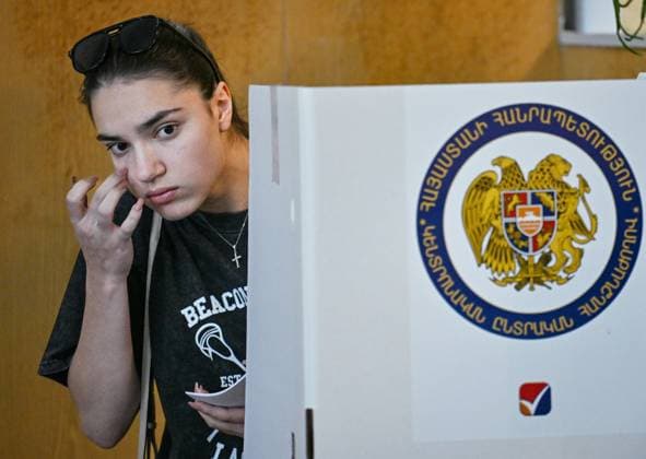 Armenia Parliamentary Election 9184612 07.06.2026 A young woman prepares to cast her ballot at a polling station during the Armenian parliamentary election in Yerevan, Armenia. Yuri Kochetkov Sputnik Yerevan Armenia  Copyright: xYurixKochetkovx