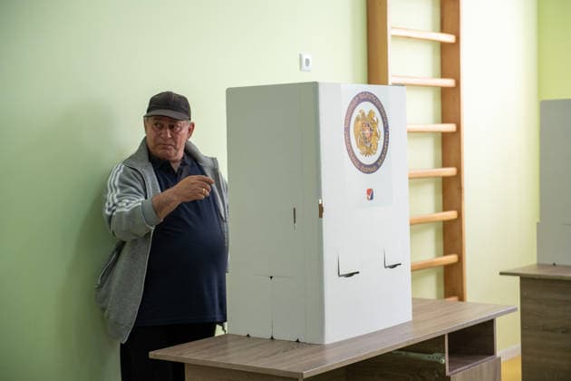 (260607) -- YEREVAN, June 7, 2026 -- A man prepares to cast his ballot at a polling station in Yerevan, Armenia, June 7, 2026. Voting began on Sunday in Armenia s parliamentary elections, with more than 2.48 million registered voters eligible to cast ballots at 2,005 polling stations across the country. Polling stations opened at 8:00 a.m. local time (0400 GMT) and will close at 8:00 p.m. local time. ) ARMENIA-YEREVAN-PARLIAMENTARY ELECTIONS-VOTING ChenxJunfeng 