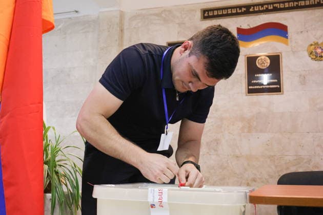 ARMENIA, YEREVAN - JUNE 7, 2026: An observer approaches a ballot box as a polling station closes during the 2026 Armenian parliamentary election. Alexander Patrin TASS  93515924