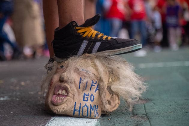 A member of the Otomi indigenous community residing in Mexico City steps on a U.S President Donald Trump latex mask during the Anti-World Cup rally as a protest against forced displacement and in memory of activist Samir Flores as part of the protests against the 2026 FIFA World Cup. on June 6, 2026 in Mexico City, Mexico. Mexico City Mexico - ZUMAe321 20260606_zia_e321_048 Copyright: xMarcoxGonzalezx