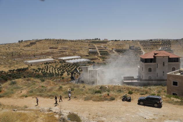 Israeli Forces Demolish Palestinian Home and Workshop Near Hebron Israeli bulldozers demolish the two-story home of Palestinian resident Nayef Abu Sneineh and a carpentry workshop in the Khirbet Qalqas area south of Hebron in the occupied West Bank, on June 8, 2026, as Palestinians inspect the rubble and damage at the site. Photo by Mamoun Wazwaz apaimages Hebron West Bank Palestinian Territory 080626_Hebron_MW_01(6) Copyright: xapaimagesxMamounxWazwazx xapaimagesx