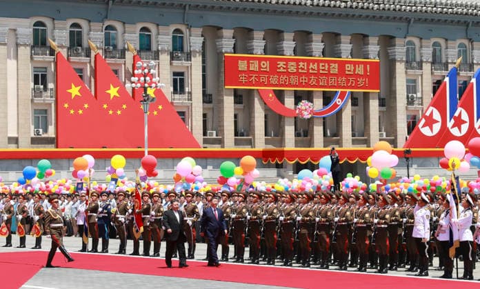 (260608) -- PYONGYANG, June 8, 2026 -- Xi Jinping, general secretary of the Communist Party of China Central Committee and Chinese president, accompanied by Kim Jong Un, general secretary of the Workers Party of Korea and president of the State Affairs of the Democratic People s Republic of Korea (DPRK), inspects the honor guard of the three services of the Korean People s Army in Pyongyang, the DPRK, June 8, 2026. Kim held a grand welcome ceremony for Xi at Kim Il Sung Square in Pyongyang. ) DPRK-PYONGYANG-CHINA-XI JINPING-KIM JONG UN-WELCOME CEREMONY DingxLin 