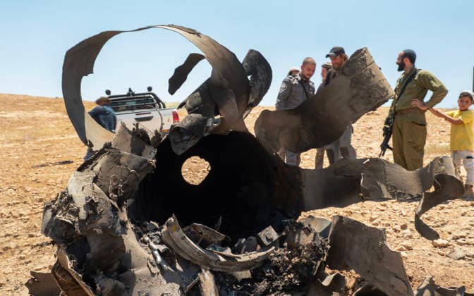 Israeli military personnel and Jewish settlers look at the remains of anIranian ballistic that was removed from the desert landscape in the area near Jericho, in the West Bank on Monday, June 8, 2026 after it was intercepted by Israel and fell to the desert. Iran fired barrages of missiles and Israel carried out military strikes on both Beirut and Iran. Both Iran and Israel have signaled they would wind down the military escalation that shattered the two month ceasefire.  ISR20260608007 JimxHollander