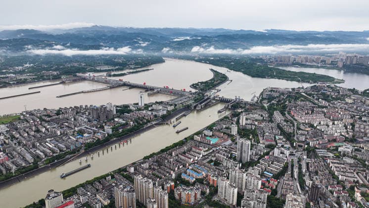 (260608) -- YICHANG, June 8, 2026 -- An aerial drone photo taken on June 8, 2026 shows the upgrading site of navigation facilities at Gezhouba in Yichang, central China s Hubei Province. China on Monday began construction of a mega waterway project, including what is expected to become the world s largest inland ship lock, in response to the rising shipping demand along the Yangtze, the world s third-longest river. The 77.2-billion-yuan (about 11.3 billion U.S. dollars) project will add a five-tier, dual-track ship lock north of the existing lock at the Three Gorges Dam, the world s largest water conservancy project, and upgrade navigation facilities at a smaller downstream dam. The new ship lock and its approach channels, which toge 