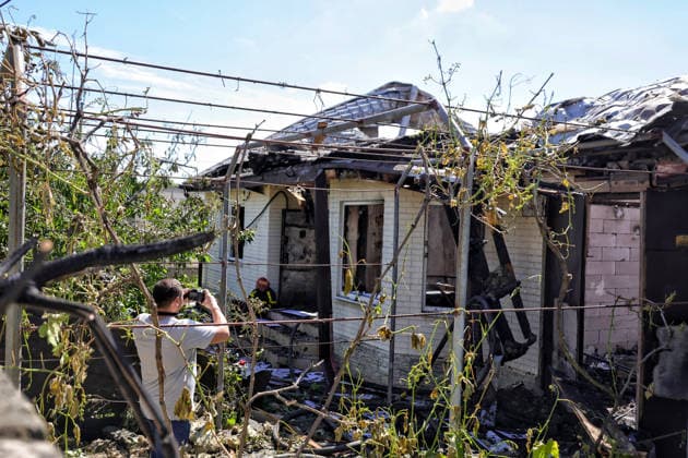 A man takes a picture of a house, damaged by a Russian drone attack, Oleksandrivka village, Odesa region, Ukraine, June 8, 2026. (Photo by Nina Liashonok Ukrinform) Russian troops attack Odesa and region with drones  Copyright: xNinaxLiashonokx