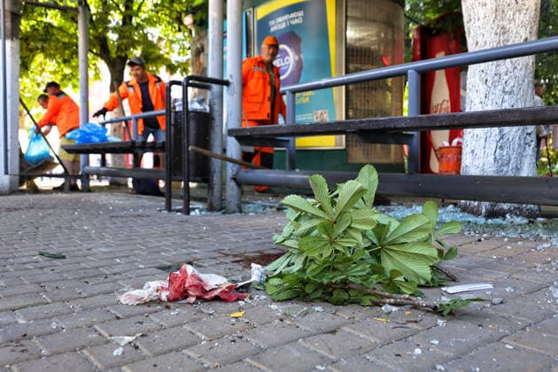 A blood-soaked wipe and a chestnut branch lie on the ground at a public transport stop as municipal workers sweep away glass shards after a Russian drone attack, Odesa, Ukraine, June 8, 2026. Russian forces attacked the southern Ukrainian city with Shahed-type drones. The wreckage of a downed drone fell directly onto a public transport stop, damaging the stop itself, as well as a control room, and several shared taxis. Three people were injured. (Photo by Nina Liashonok Ukrinform) Russian troops attack Odesa and region with drones  Copyright: xNinaxLiashonokx