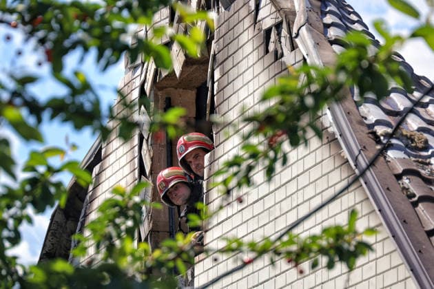 Two firefighters look out of a rooftop window, knocked out in a house by a Russian drone attack, Oleksandrivka village, Odesa region, Ukraine, June 8, 2026. (Photo by Nina Liashonok Ukrinform) Russian troops attack Odesa and region with drones  Copyright: xNinaxLiashonokx