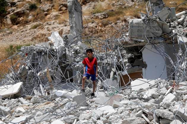 (260608) -- HEBRON, June 8, 2026 -- A Palestinian inspects the rubble after Israeli excavators demolished a Palestinian home and a carpentry workshop in the Khirbet Qalqas area, south of Hebron, in the West Bank, on June 8, 2026. (Photo by Xinhua) MIDEAST-HEBRON-DEMOLITION MamounxWazwaz 