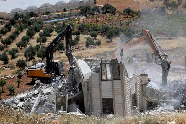 (260608) -- HEBRON, June 8, 2026 -- Israeli excavators demolish a Palestinian home and a carpentry workshop in the Khirbet Qalqas area, south of Hebron, in the West Bank, on June 8, 2026. (Photo by Xinhua) MIDEAST-HEBRON-DEMOLITION MamounxWazwaz 