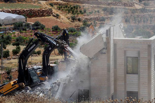Israeli Residential Building Demolishment West Bank Israeli army heavy machinery demolishes a residential building in the village of Khirbet Qalqas, south of Hebron, in the occupied West Bank, on June 8, 2026. The Israeli army demolished the six-apartment building, which housed 16 people, citing a lack of building permits in Area C. Hebron West Bank Palestinian Territories Copyright: xMosabxShawerx