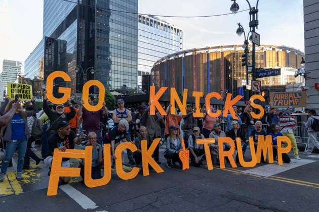 June 8, 2026, New York, New York, USA: Protesters hold letters that read GO KNICKS FUCK TRUMP, signs that read IMPEACH CONVICT REMOVE AIRBALL TRUMP outside Madison Square Garden as fans enter the stadium for game 3 of the NBA finals. Security is high in Midtown Manhattan with street closures, portable fences, barricades and heavy police presence for President Trump s attendance at the basketball game. New York USA - ZUMAr174 20260608_znp_r174_003 Copyright: xGinaxMxRandazzox