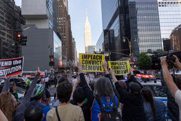 June 8, 2026, New York, New York, USA: Protesters hold up signs that read IMPEACH CONVICT REMOVE as President Trump s motorcade travels to Madison Square Garden for his attendance at game 3 of the NBA finals. Security is high in Midtown Manhattan with street closures, portable fences, barricades and heavy police presence for President Trump s attendance at the basketball game. New York USA - ZUMAr174 20260608_znp_r174_006 Copyright: xGinaxMxRandazzox