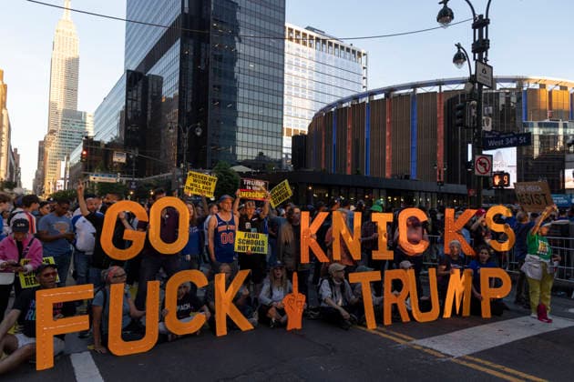 June 8, 2026, New York, New York, USA: Protesters hold letters that read GO KNICKS FUCK TRUMP, signs that read FUND SCHOOLS NOT WAR outside Madison Square Garden as fans enter the stadium for game 3 of the NBA finals. Security is high in Midtown Manhattan with street closures, portable fences, barricades and heavy police presence for President Trump s attendance at the basketball game. New York USA - ZUMAr174 20260608_znp_r174_013 Copyright: xGinaxMxRandazzox